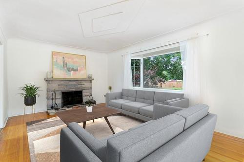 Virtually staged - 40 Robroy Avenue, Hamilton, ON - Indoor Photo Showing Living Room With Fireplace