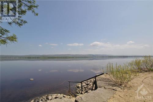 Beach access offers a handrail and sturdy steps. - 620 Bayview Drive, Ottawa, ON - Outdoor With Body Of Water With View