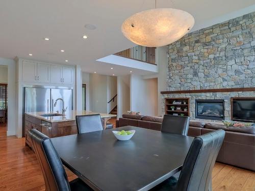 1854 Hidden Lake Place, Kelowna, BC - Indoor Photo Showing Dining Room With Fireplace