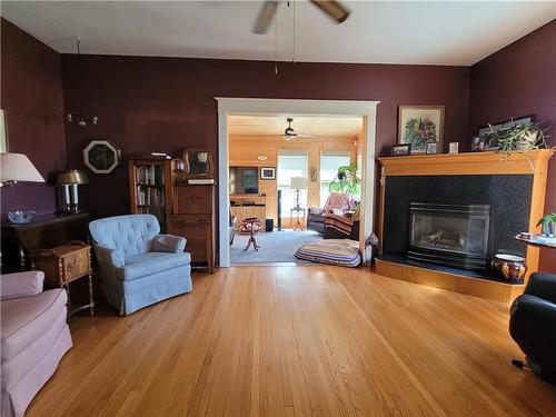 56064 12 Road W, Cartier Rm, MB - Indoor Photo Showing Living Room With Fireplace