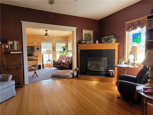 56064 12 Road W, Cartier Rm, MB - Indoor Photo Showing Living Room With Fireplace