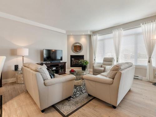 Living room - 307-20 Rue Des Émeraudes, Repentigny (Repentigny), QC - Indoor Photo Showing Living Room With Fireplace