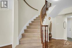 Curved staircase to the 2nd level. - 