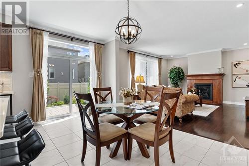 New light fixture - 63 Boddington Street, Ottawa, ON - Indoor Photo Showing Dining Room With Fireplace