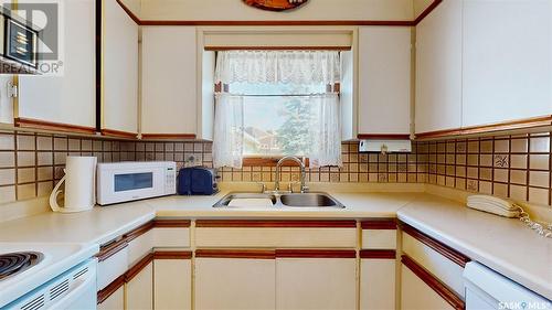 56 Atchison Crescent, Regina, SK - Indoor Photo Showing Kitchen With Double Sink