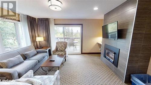 1235 Deerhurst - Greens Drive Unit# 31-101, Huntsville, ON - Indoor Photo Showing Living Room With Fireplace