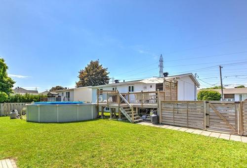 Backyard - 5612 Rue Alain, Brossard, QC - Outdoor With Above Ground Pool