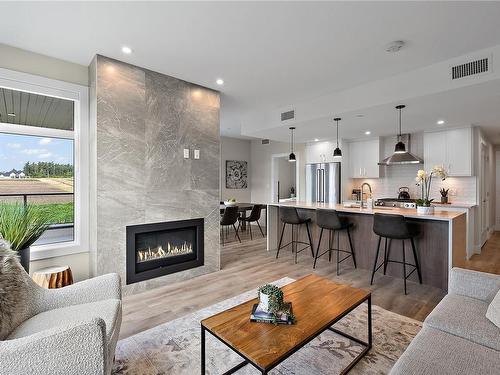 203-2520 Hackett Cres, Central Saanich, BC - Indoor Photo Showing Living Room With Fireplace