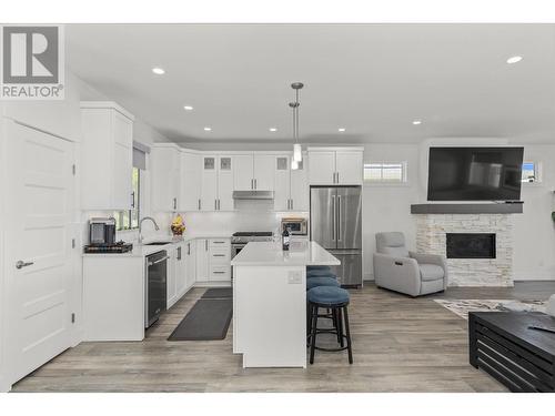 1575 Summer Crescent, Kelowna, BC - Indoor Photo Showing Kitchen With Fireplace With Upgraded Kitchen