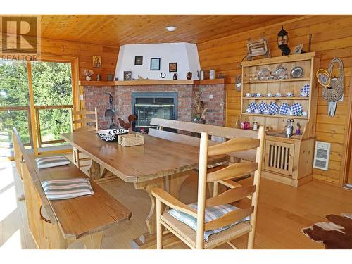 6328 North Shore Drive, 100 Mile House, BC - Indoor Photo Showing Dining Room With Fireplace