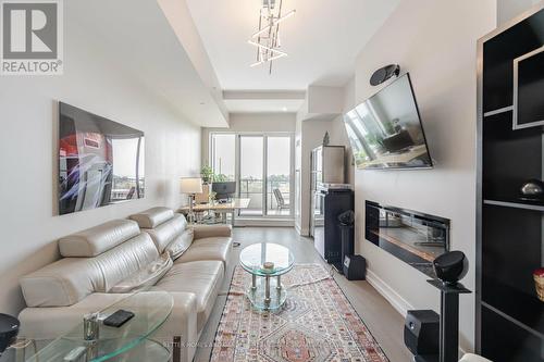 312 - 20 Shore Breeze Drive, Toronto (Mimico), ON - Indoor Photo Showing Living Room With Fireplace