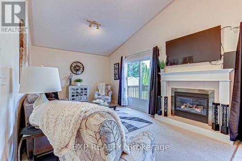 37 Peach Street E, Tillsonburg, ON - Indoor Photo Showing Bedroom With Fireplace