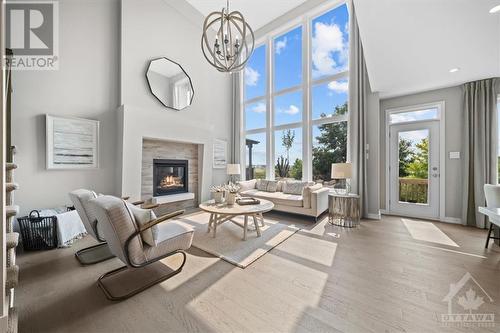 Great Room showcasing Cardel's signature wall of windows - 106 Westphalian Avenue, Ottawa, ON - Indoor Photo Showing Living Room With Fireplace