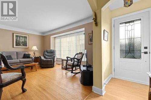 Living room & front foyer with gorgeous steel entrance door & ornate half glass. - 815 Joseph Street E, Cardinal, ON - Indoor Photo Showing Living Room