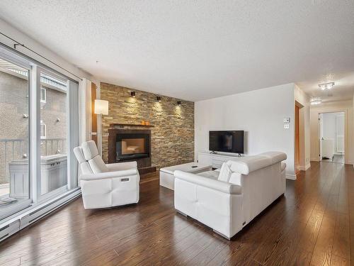 Living room - 201-718 Place De Monaco, Laval (Chomedey), QC - Indoor Photo Showing Living Room With Fireplace