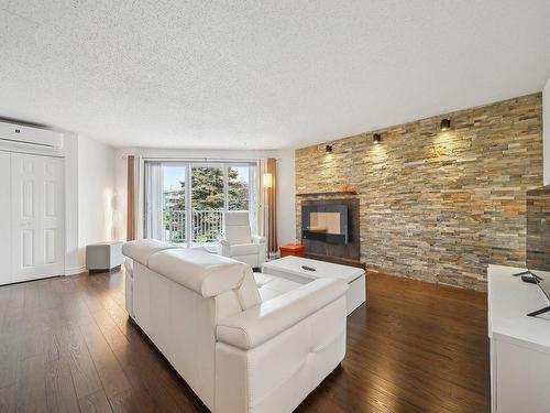 Living room - 201-718 Place De Monaco, Laval (Chomedey), QC - Indoor Photo Showing Living Room With Fireplace