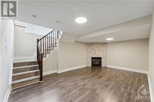 Lovely finshed family room in lower level wiht gas fireplace - 109 Hawkeswood Drive, Ottawa, ON - Indoor With Fireplace