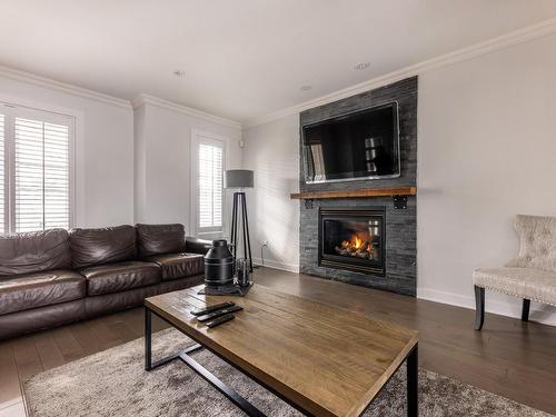 Living room - 343 Rue François-Cotineau, Terrebonne (Lachenaie), QC - Indoor Photo Showing Living Room With Fireplace