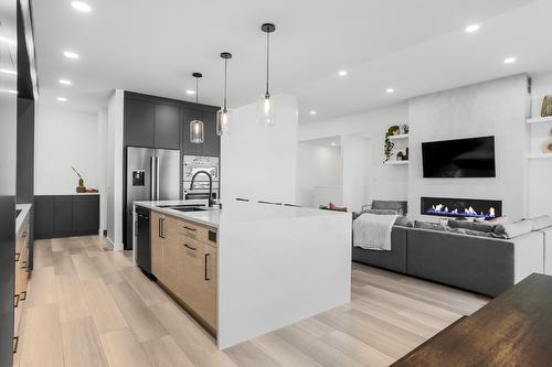 208 Skyland Drive, Kelowna, BC - Indoor Photo Showing Kitchen With Fireplace With Upgraded Kitchen