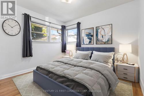 Virtually staged bedroom with blue shears/curtains - 225 Dawn Drive, London, ON - Indoor Photo Showing Bedroom