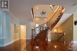 Curved hardwood staircase with wrought iron spindles - 