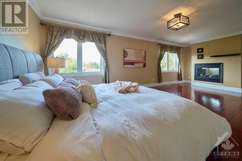 primary bedroom with fireplace and 5pc ensuite - 1030 Goward Drive, Kanata, ON - Indoor Photo Showing Bedroom