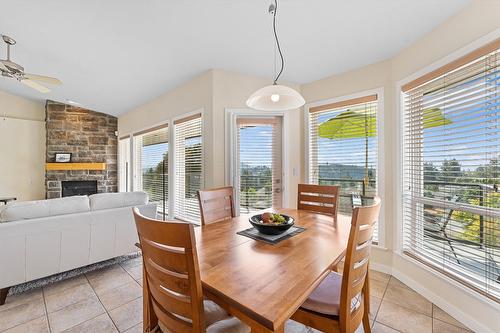 2243 Shannon Hills Place, Kelowna, BC - Indoor Photo Showing Dining Room With Fireplace