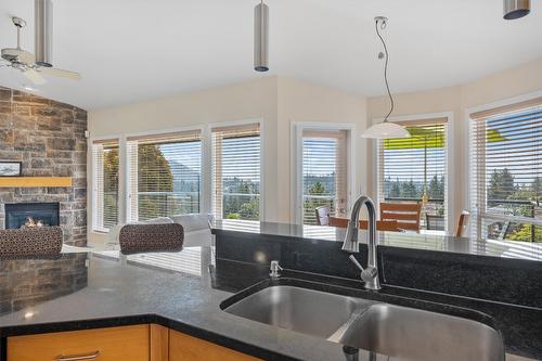 2243 Shannon Hills Place, West Kelowna, BC - Indoor Photo Showing Kitchen With Fireplace With Double Sink