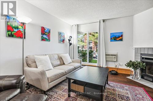 312 - 1450 Glen Abbey Gate, Oakville, ON - Indoor Photo Showing Living Room With Fireplace