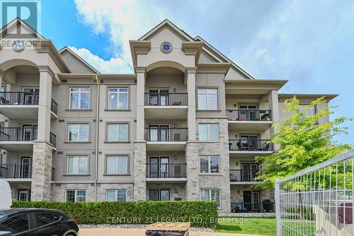 214 - 1460 Main Street E, Milton (Dempsey), ON - Outdoor With Balcony With Facade