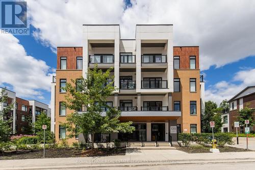 210 - 120 Canon Jackson Drive, Toronto (Beechborough-Greenbrook), ON - Outdoor With Balcony With Facade