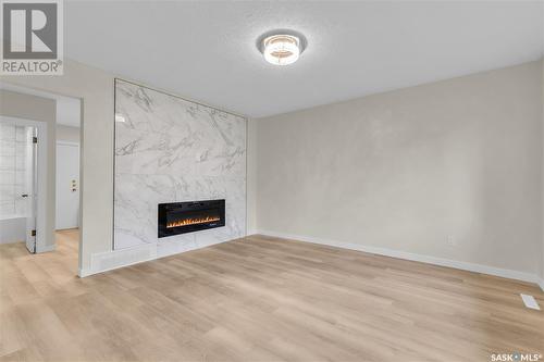 705 Taylor Street E, Saskatoon, SK - Indoor Photo Showing Living Room With Fireplace