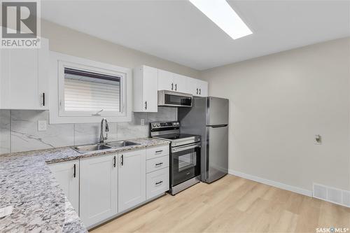 705 Taylor Street E, Saskatoon, SK - Indoor Photo Showing Kitchen With Double Sink