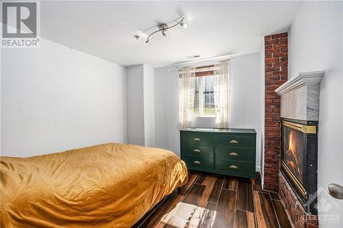 297 Dupuis Street Unit#107, Ottawa, ON - Indoor Photo Showing Bedroom With Fireplace