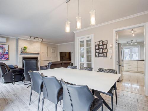 Dining room - 370 Rue Léotable-Dubuc, La Prairie, QC - Indoor Photo Showing Dining Room With Fireplace