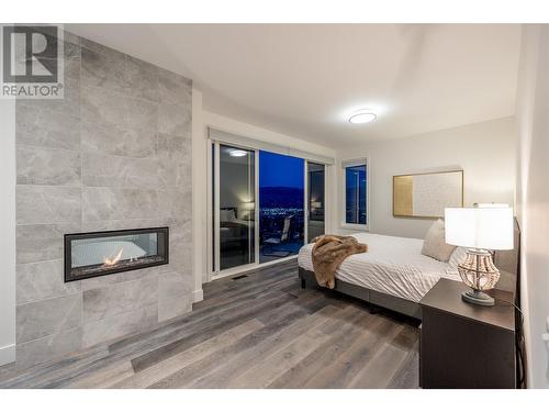 737 Highpointe Drive, Kelowna, BC - Indoor Photo Showing Bedroom With Fireplace