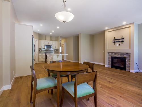 136-1675 Penticton Avenue, Penticton, BC - Indoor Photo Showing Dining Room With Fireplace