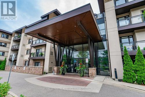 417 - 128 Garden Drive, Oakville, ON - Outdoor With Balcony With Facade