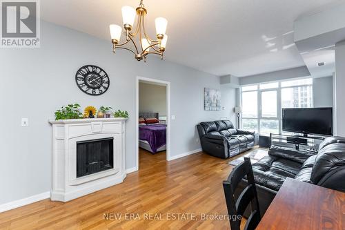 1606 - 21 Grand Magazine Street, Toronto (Niagara), ON - Indoor Photo Showing Living Room With Fireplace