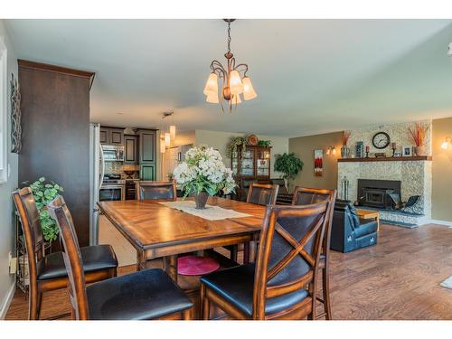 103 Johnson Road, Fruitvale, BC - Indoor Photo Showing Dining Room With Fireplace