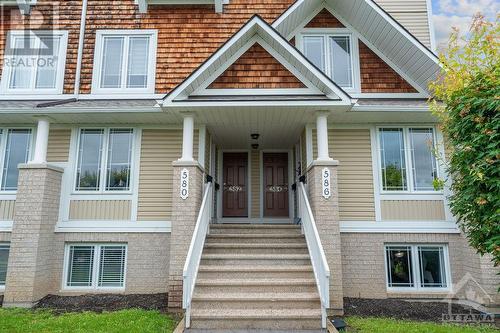 Stairs leading to front entrance of end unit. - 586 Lakeridge Drive, Ottawa, ON - Outdoor With Facade