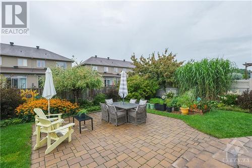 Outside, the beautifully landscaped backyard features an interlock deck and full perennial garden perfect for entertaining or enjoying the outdoors. - 500 Kerria Walk, Ottawa, ON - Outdoor