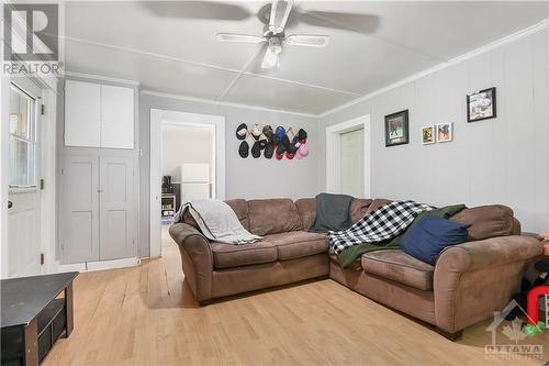 Door behind couch leads to storage shed. Great for lawn tools! - 873 Raglan Street S, Renfrew, ON - Indoor Photo Showing Living Room