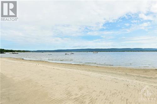 Can you feel the sand between your toes? - 134 Bayview Drive, Ottawa, ON - Outdoor With Body Of Water With View