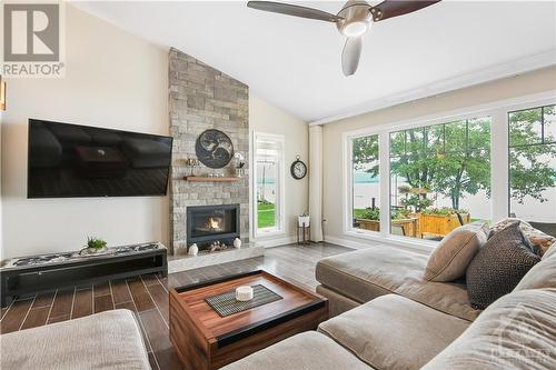 Blinds on river side are power, remote control close and tilt. - 134 Bayview Drive, Ottawa, ON - Indoor Photo Showing Living Room With Fireplace