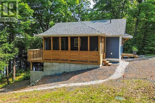 Side view w/screened porch. - 1325 Nordic Road, Arden, ON - Outdoor