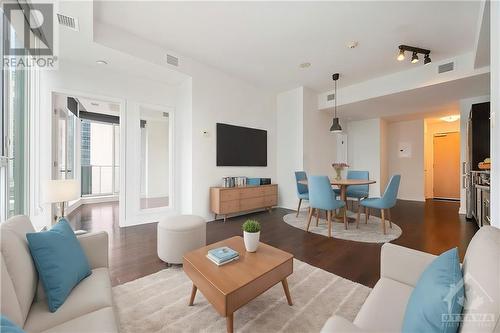 This photo has been virtually staged. - 40 Nepean Street Unit#1003, Ottawa, ON - Indoor Photo Showing Living Room