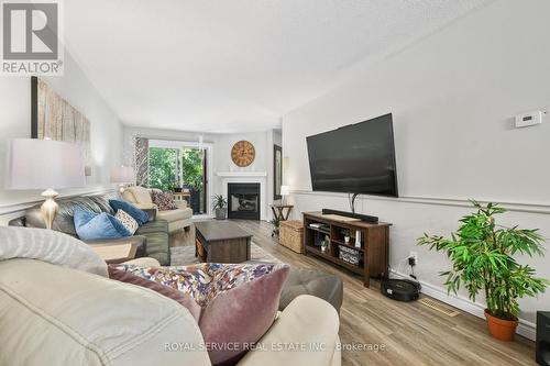 103 - 245 Elgin Street W, Cobourg, ON - Indoor Photo Showing Living Room With Fireplace