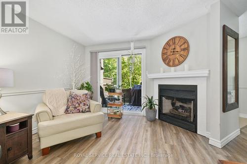 103 - 245 Elgin Street W, Cobourg, ON - Indoor Photo Showing Living Room With Fireplace