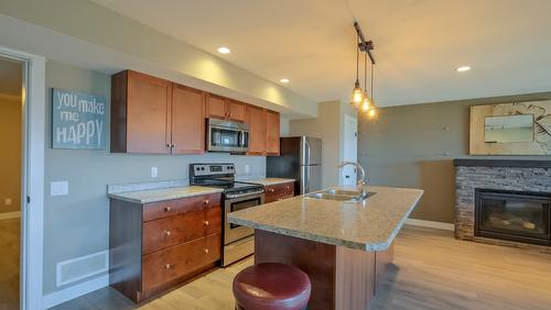 1257 Feedham Avenue, Kelowna, BC - Indoor Photo Showing Kitchen With Fireplace With Stainless Steel Kitchen With Double Sink